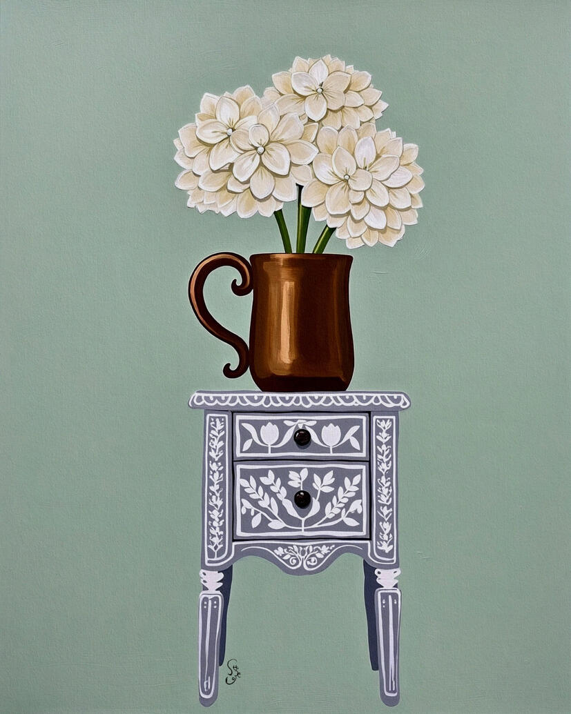 Art print of a bronze pitcher with three cream white hydrangea flowers on a white and grey vintage decorative side table against a light sage green background.