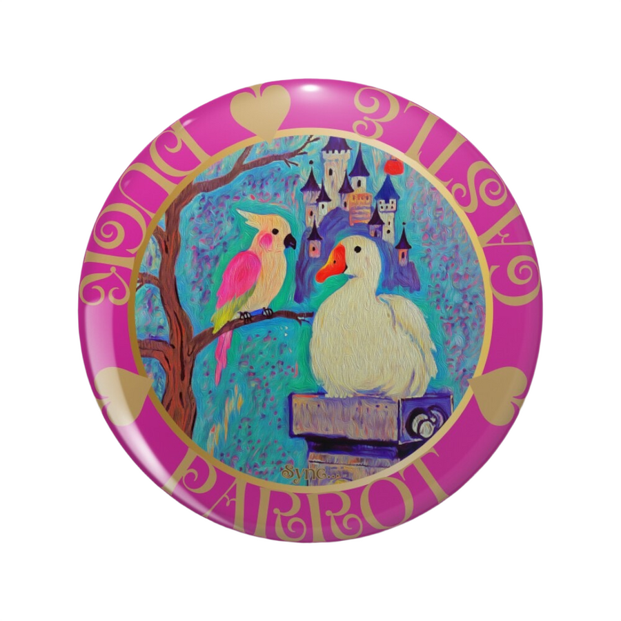An ornate round pink back button close up, containing an illustration of a pink parrot and white duck together before a vivid castle scene. Hover Text reads “Visit Redbubble to collect the Pin Button"