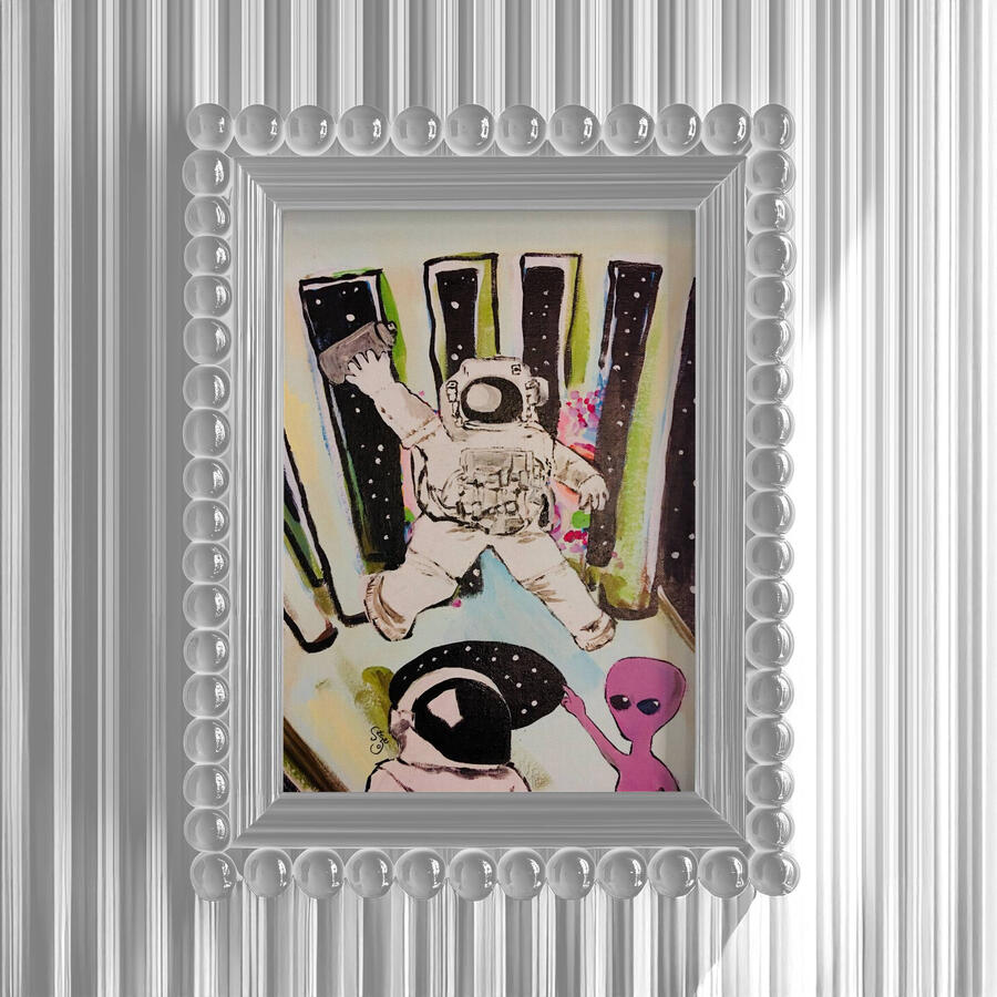 hand-drawn space scene with an astronaut, a small pink alien, black starry shapes, and a floating bottle-like object. It feels curious and slightly chaotic, like a strange little mission caught between play and confusion. Framed in translucent bubble bead